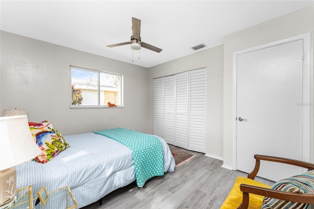 bedroom with a closet, ceiling fan, and light hardwood / wood-style flooring