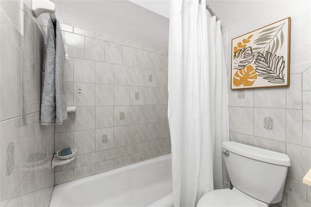 bathroom featuring tile walls, shower / bath combo with shower curtain, and toilet