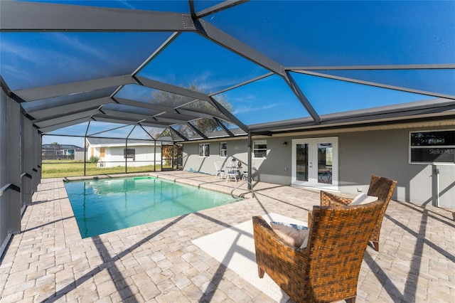 view of pool with a patio area, french doors, and glass enclosure