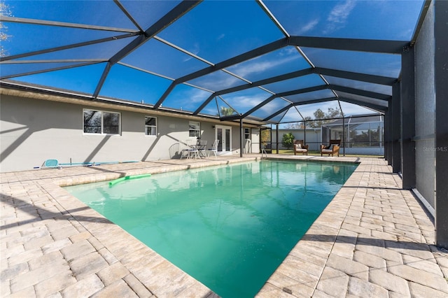 view of swimming pool with a patio area and a lanai