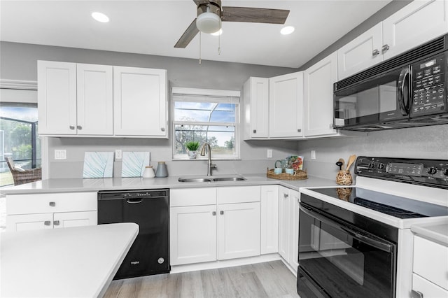 kitchen with ceiling fan, white cabinetry, black appliances, light hardwood / wood-style floors, and sink