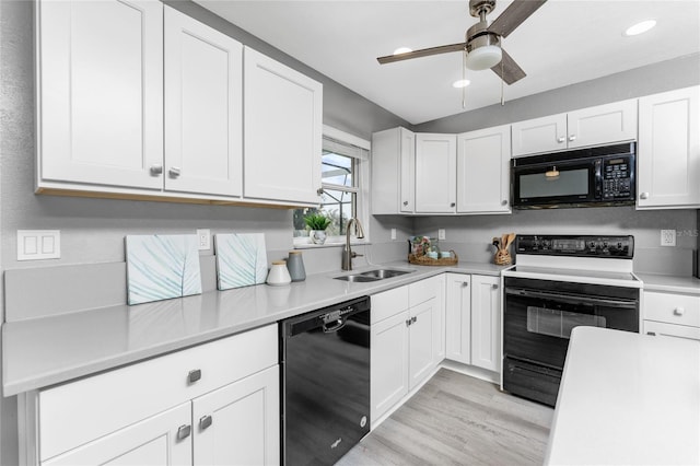 kitchen with white cabinets, ceiling fan, light wood-type flooring, black appliances, and sink