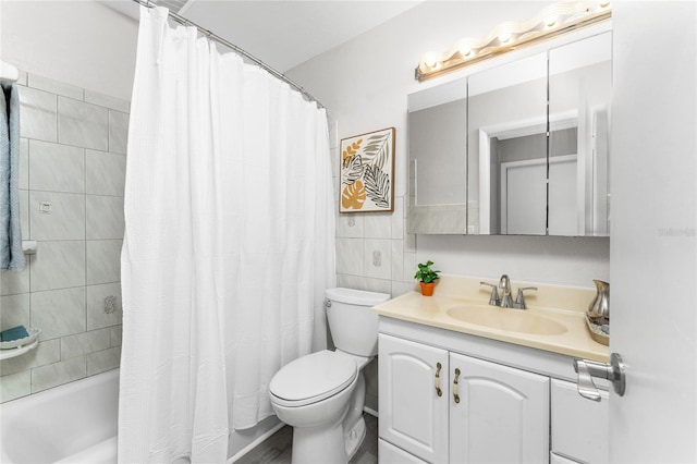 full bathroom featuring toilet, shower / tub combo with curtain, vanity, and tile walls