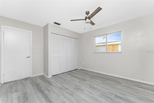 unfurnished bedroom with a closet, light hardwood / wood-style floors, and ceiling fan