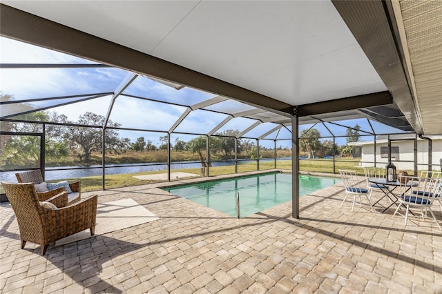 view of pool featuring a patio area, a lanai, and a water view