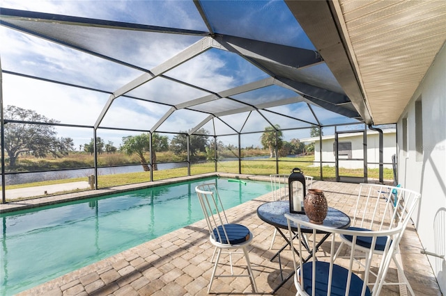 view of swimming pool featuring a water view, a patio area, and glass enclosure