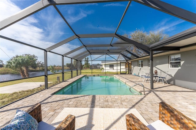 view of swimming pool with a patio area, a lanai, a lawn, and a water view