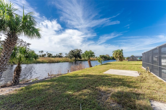 view of yard featuring a water view and a lanai