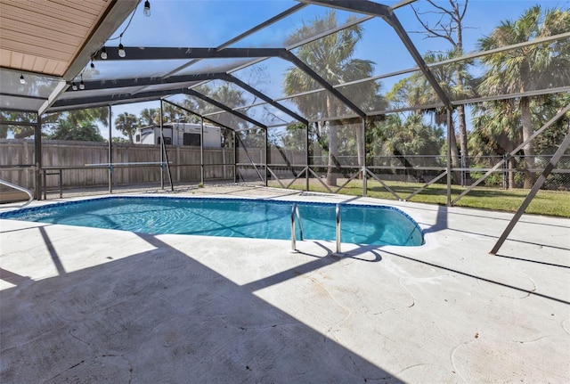 view of swimming pool with a patio and glass enclosure