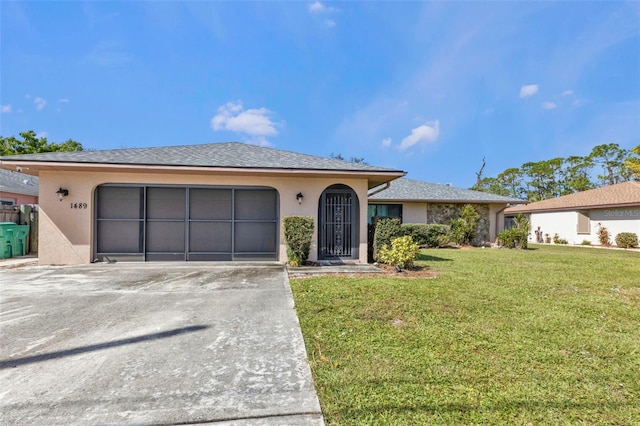 ranch-style house with a front yard and a garage