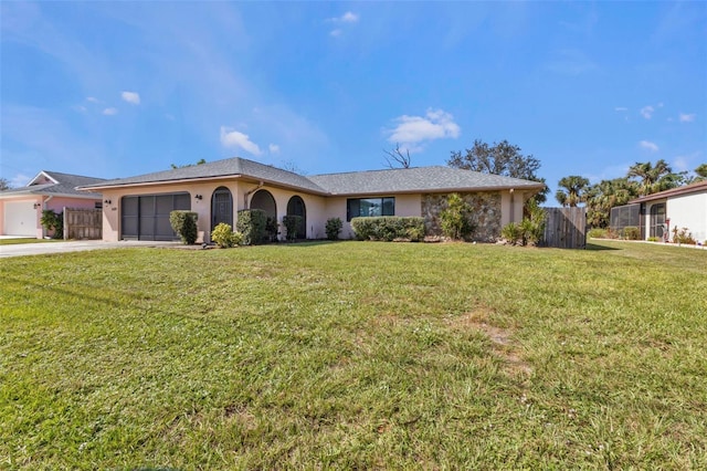 ranch-style home featuring a garage and a front lawn