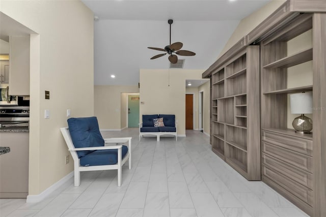 living area featuring ceiling fan and vaulted ceiling