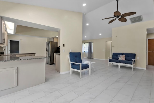 living room featuring ceiling fan, high vaulted ceiling, and sink