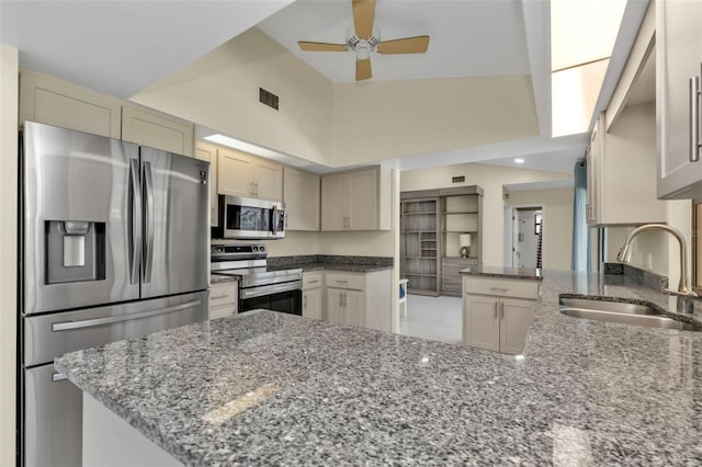 kitchen with kitchen peninsula, stainless steel appliances, and sink