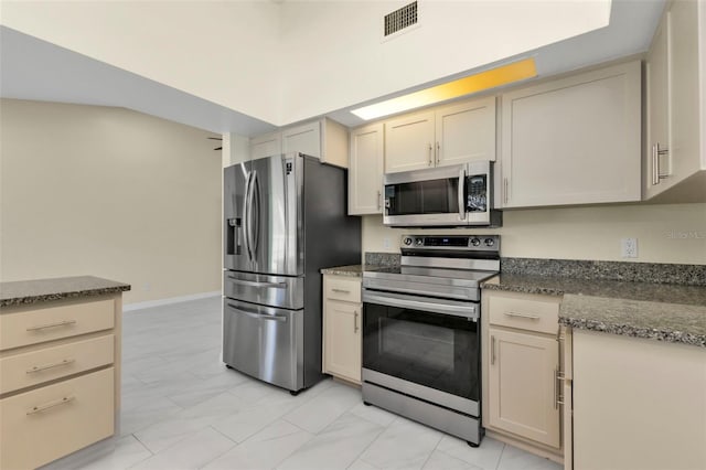 kitchen with stainless steel appliances and cream cabinets