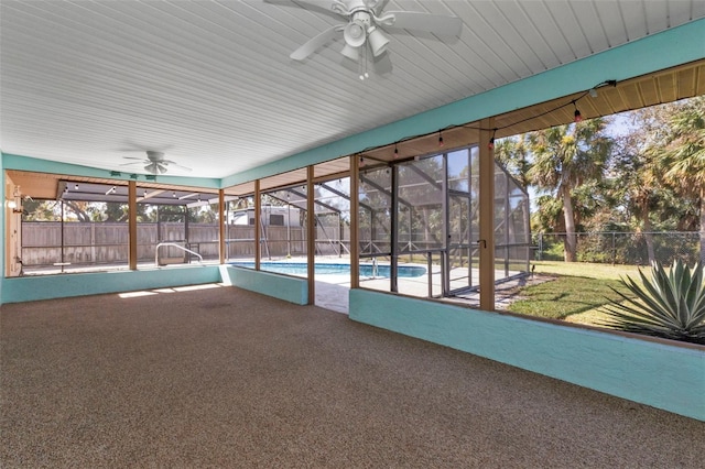 unfurnished sunroom with ceiling fan and a wealth of natural light