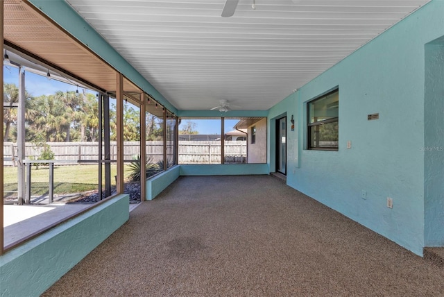 unfurnished sunroom with a wealth of natural light and ceiling fan