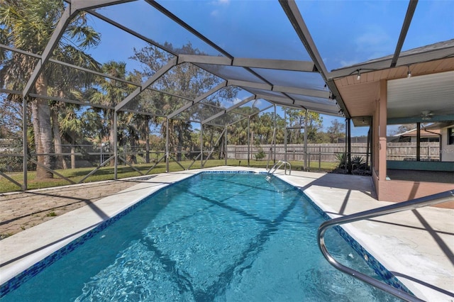 view of swimming pool featuring a patio area and a lanai