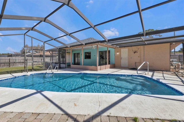 view of swimming pool with a patio and glass enclosure