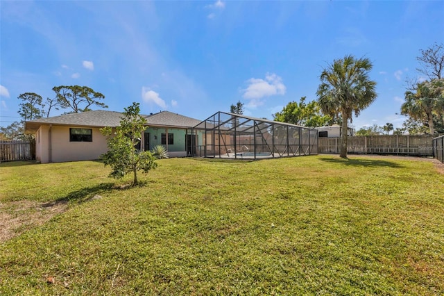 view of yard featuring a pool and glass enclosure