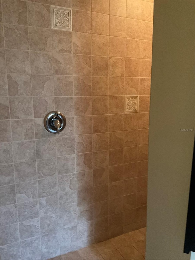 bathroom with tiled shower