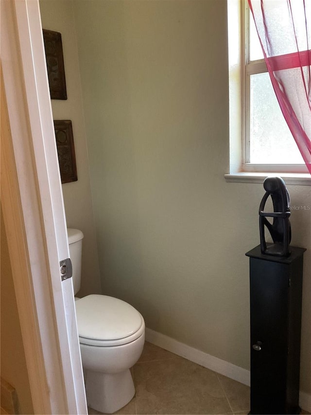 bathroom featuring toilet and tile patterned floors