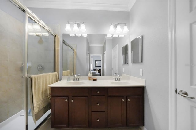 bathroom featuring vanity, crown molding, and a shower with shower door