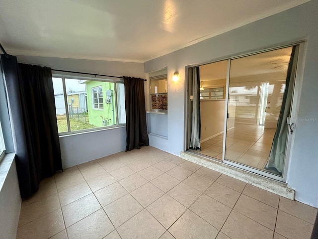 unfurnished room featuring crown molding and light tile patterned flooring