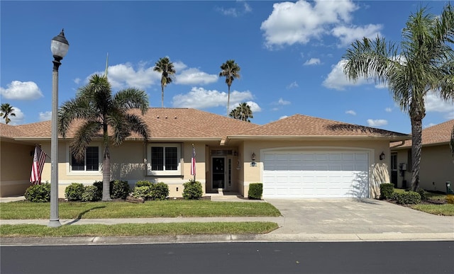 single story home with a front yard and a garage