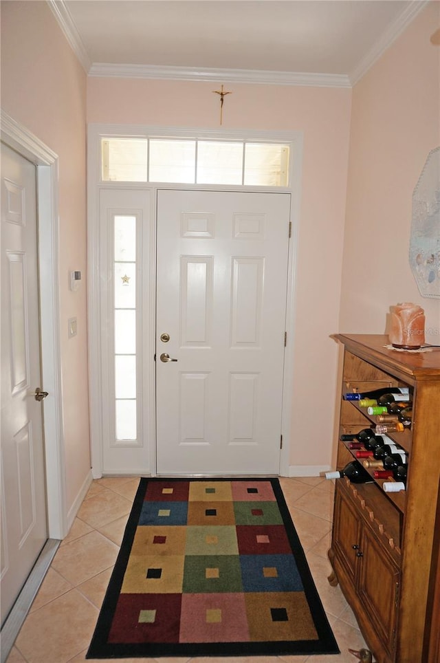 foyer entrance featuring ornamental molding and light tile patterned flooring