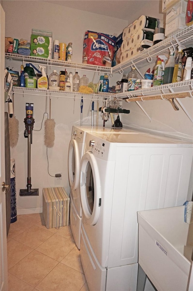 washroom featuring separate washer and dryer and light tile patterned floors