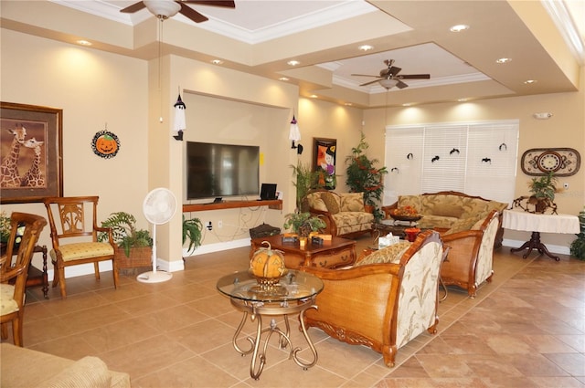 tiled living room with ceiling fan, a raised ceiling, and crown molding