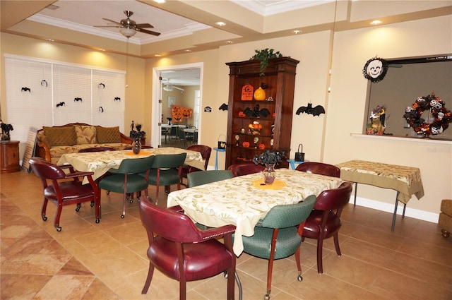 dining area with crown molding, light tile patterned flooring, a raised ceiling, and ceiling fan