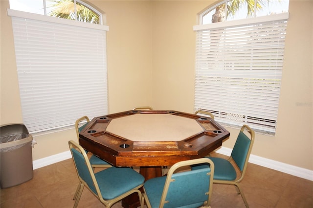 game room featuring a baseboard radiator and tile patterned flooring