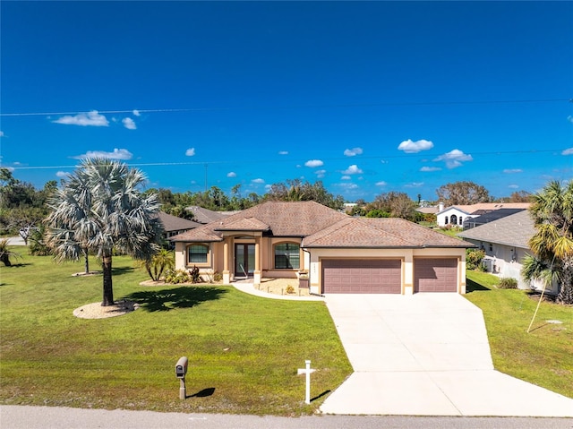 mediterranean / spanish house with a front lawn and a garage