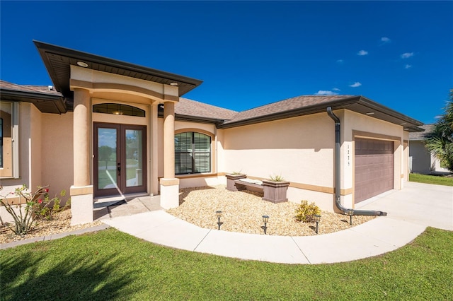 view of front of home with a front yard and a garage