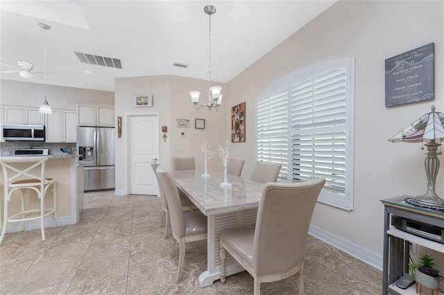 dining space with ceiling fan with notable chandelier