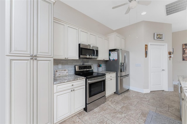 kitchen with backsplash, white cabinetry, appliances with stainless steel finishes, light stone counters, and ceiling fan