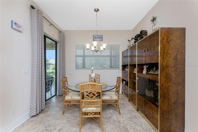 dining space with an inviting chandelier