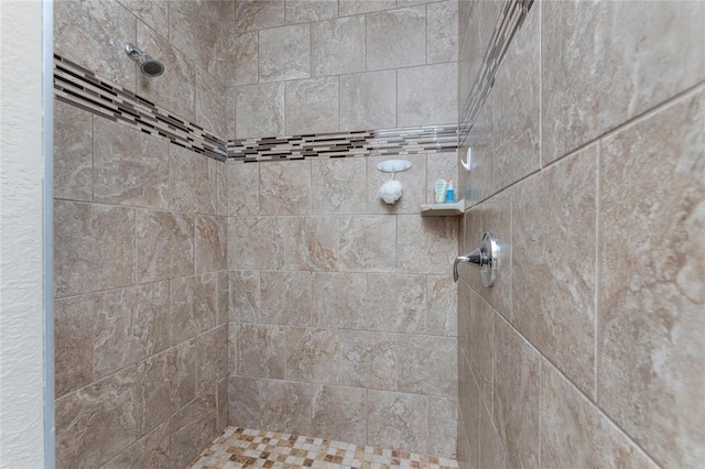 bathroom with a tile shower