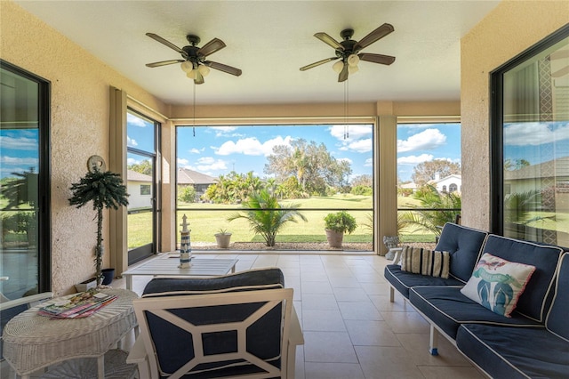 sunroom / solarium with a healthy amount of sunlight and ceiling fan