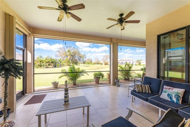 sunroom / solarium featuring plenty of natural light and ceiling fan