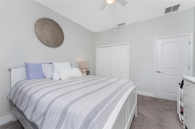 bedroom with a closet, ceiling fan, and light colored carpet