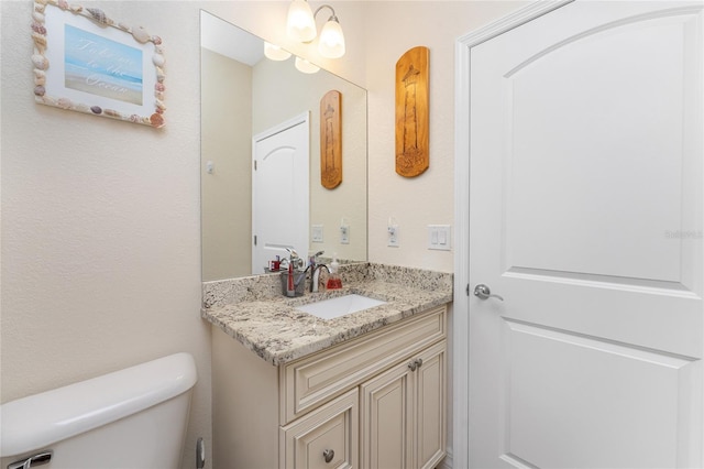 bathroom featuring toilet and vanity