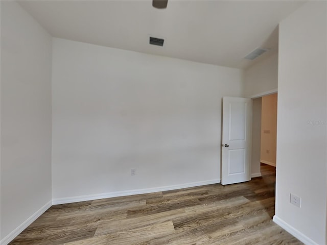 unfurnished room with hardwood / wood-style floors