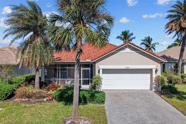 view of front of property featuring a front lawn and a garage