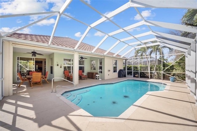 view of pool with ceiling fan, a lanai, and a patio area