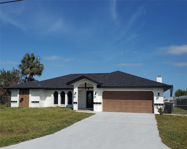 ranch-style home featuring a front lawn and a garage