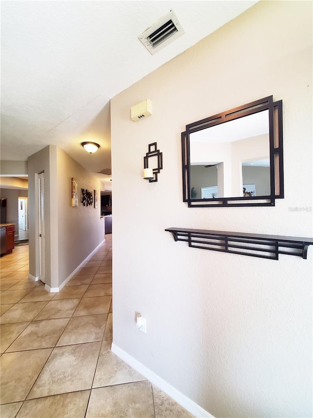 509 Clearview Dr, Port Charlotte, FL 33953 - corridor featuring light tile patterned floors and baseboards