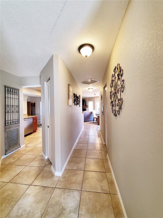 509 Clearview Dr, Port Charlotte, FL 33953 - corridor with light tile patterned floors, a textured ceiling, and baseboards